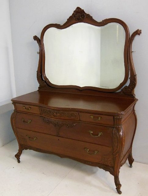 Carved Victorian dresser with wishbone mirror: 2 large drawers, 3 small on top, bombe sides, serpentine front, slide on side. Approx. 54.5" W x 25.25" x 34" H (66" H with mirror)