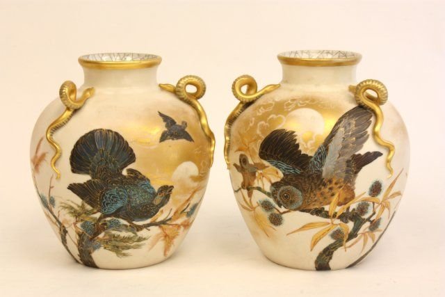 Pair Royal Worcester vases: With "Snake" arms for handles, depicting "Birds in Flight", unmarked. 1 has small inside repair to rim. Approx. 9.5" H. The base has been drilled and the holes have been filled.
