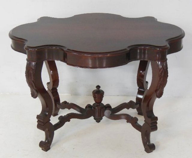 Mahogany Victorian turtle top table: Stretcher base with finial. Approx. 40" x 29" x 28" H.