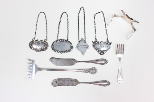 Group lot odd pieces of sterling silver: Including: Relish fork, baby fork, 2 butter knives, liquor tags & place card holder. Approx. 5 ozt. From the collection of a New Brunswick Victorian Mansion.