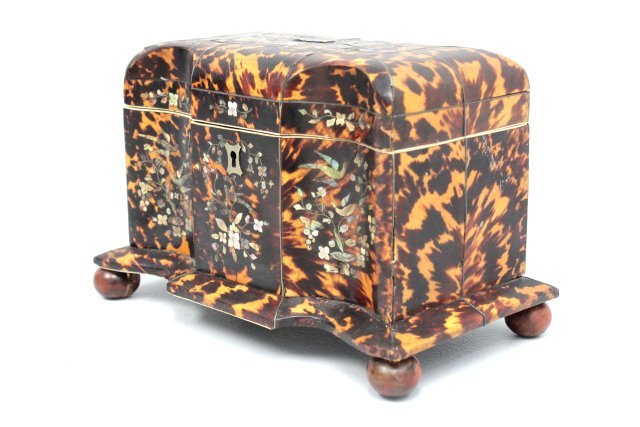 19th c. large size tortoise shell tea caddy: With mother of pearl inlay, covered fitted interior, on 4 feet, "Bird & Foliate" motif, some lines. Approx. 6" H x 7.75" x 5".