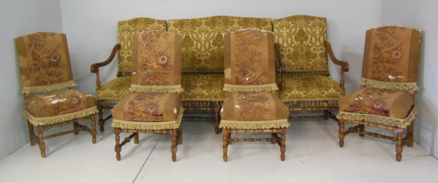 7 piece French walnut salon set: Consisting of: Loveseat - missing arm, pair arm chairs, 4 side chairs. From the Chateau des Thon, which originally was built and located outside of Dijon, France in the early 18th century.