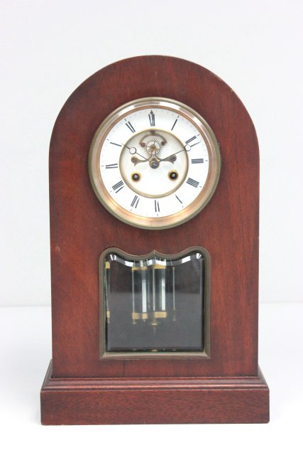 French mantle clock with dome case: Beveled glass, with key & mercury pendulum, lines on porcelain face. Approx. 17.25" H x 9.5" W.
