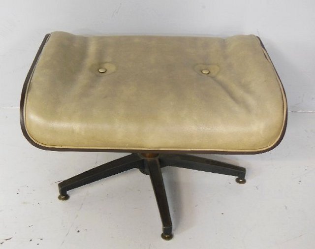 Eames swivel footstool with leather top: Approx. 26" x 22" x 14" H. From the estate of Doris Schwerin, Author.