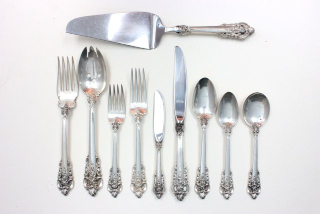 Wallace "Grand Baroque" silverware 49 pieces: Including: 9- Salad forks. 9- Dinner knives. 1- Bullion. 7- Soup spoons. 9- Dinner forks. 9- Tea spoons. 1- Pie server. 2- Pierced serving spoons. 1- Meat fork. 1- Butter knife. Worn condition.