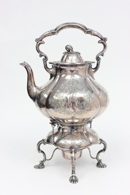 Silver plated tea kettle on stand: Silver plated tea kettle on stand.