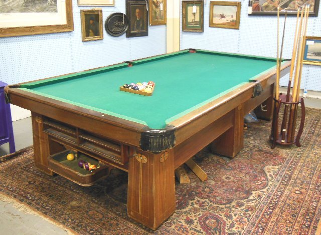 Brunswick Arts & Crafts mahogany inlaid pool table: With return system. Including: rack, balls & sticks. From a Tavern in Newark, NJ. 1 slate panel is cracked in half but fits perfectly & lays flat.