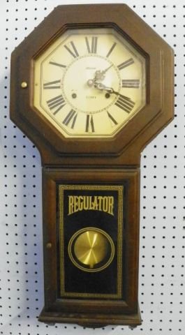 31 day regulator wall clock: In mahogany case, with pendulum & key. Approx. 30" L x 13.5" W.