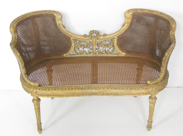 French Louis XV style settee ca. 19th c.: Losses to cane, gilt wood, heavily carved, double cane back, green seat. Aprox. 37" W x 19" D (seat), 44"W x 20.5" D x 29.5" H "(back).