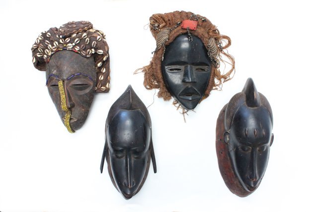4 19thc. African Masks: 1 is approx. 12" x 9" original beading and handwoven headdress with shells. 1 is approx. 9" X 8" with handbraided yarn hair, black ebony. Matched pair 'Man and Woman,' approx. 14" X 6".