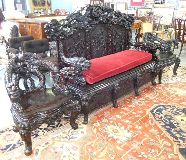 19th c. 3 piece heavily carved salon set: Depicting "Dragons". Includes settee - approx. 56" H x 63" W x 24" D. 2 chairs - approx. 32" H x 27" W x 24" D. 1 chair has dragon arms and bone eyes.