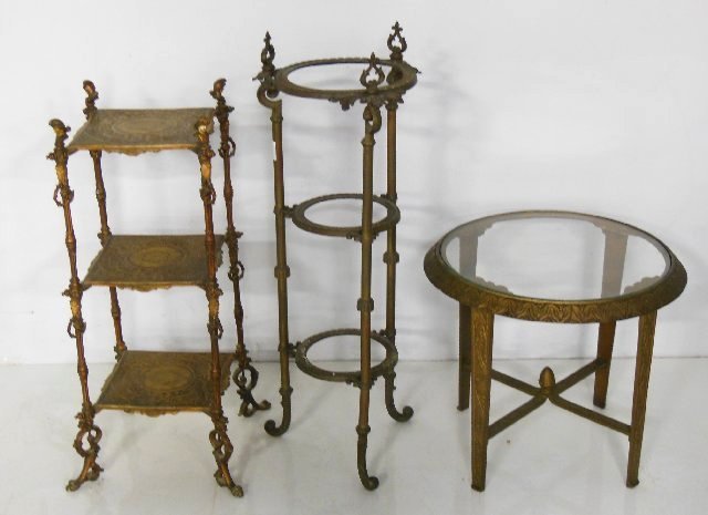 3 bronze, brass & metal tables: 1- 3 tier stand with glass inserts, approx. 35" x 13". 1- 3 tier bronze table with detailed design, approx. 31" H x 11.5" . 1- Round gilt metal deco table, approx. 18.5" x 20.5"