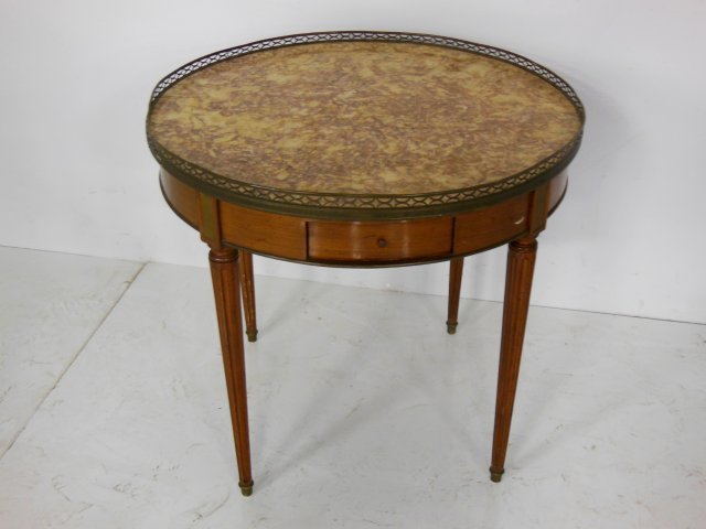 Regency style Bouiliotte table ca. 1900-20: Bronze mounted, marble top, pierced gallery. Approx. 28" H x 29.5" Diam.