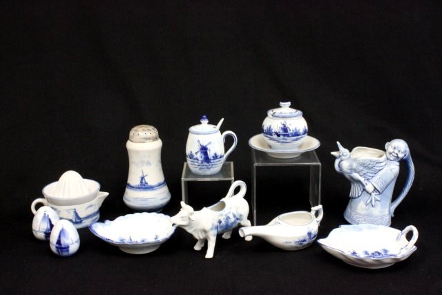 Group lot of blue & white "Dutch" porcelain: Including: Orange juicer, cruet, egg shaped salt & pepper shakers, honey pot with spoon, sugar shaker, cow creamer, figural creamer with goose, honey pot with attached underplate & 2 spoon rests. 11 p