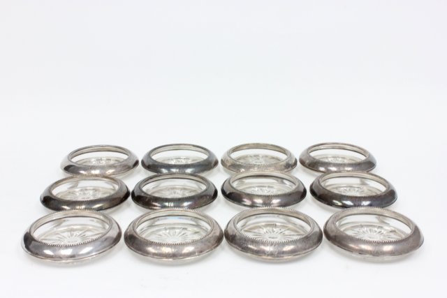 Set of 12 sterling silver rimmed coasters: (3236)