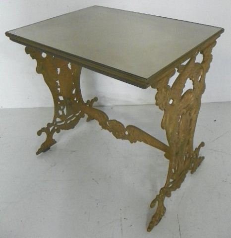 Glass top bronze table with "Cupids": Approx. 18" W x 24" L x 33" H. (2876.3)