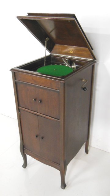 Columbia Graphinola: With a record case on bottom & speaker doors with crank. Approx. 43" H x 19.5" W x 21" D. Working condition.