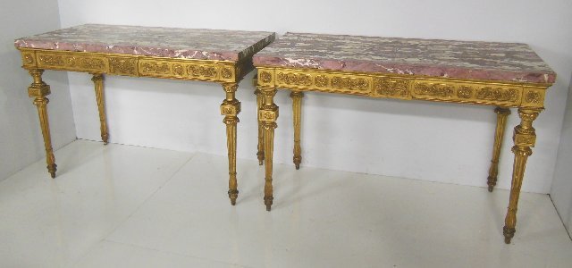 Pair book matched marble top gilded console tables: Ca. 18/19th c., from a New York City apartment. Approx 58" L x 29" D x 38" H.