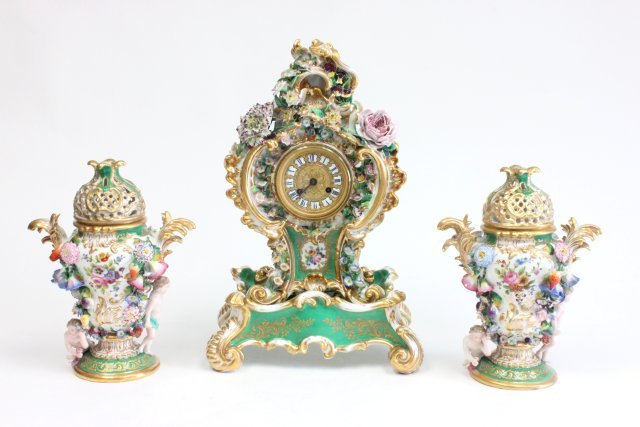 3 pc. Jacob Petit porcelain clock set: Losses & old restorations. Clock approx. 18" x 11.5" on stand. Urns approx. 11.5".