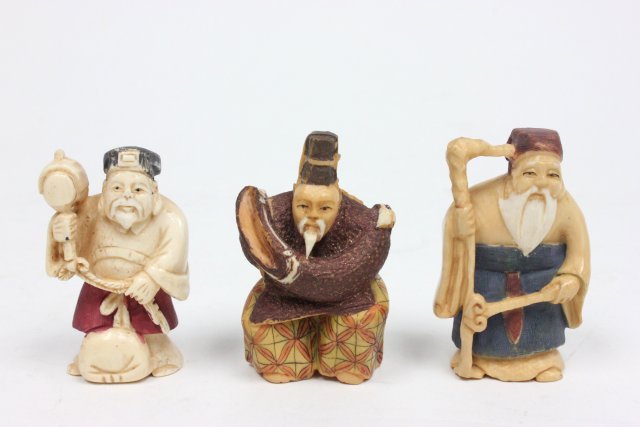 3 antique 19th c. Japanese bone Netsukes: 1 Crouching Man with Fan behind Back, 1 Man Holding Sceptre, 1 Man with Tool & Bag. Tallest approx. 2 1/16".
