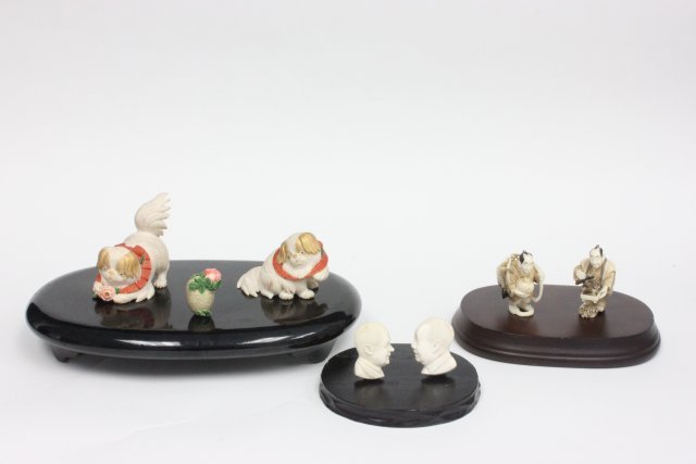 Group lot of 7 carved bone pieces artist signed: Including: 2 bone Netsukes, carved bone head of "Nixon & Chairman Mao", 2 bone carvings of dogs, 1 vase.