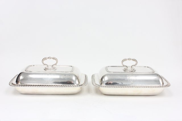 Rare pair sterling silver Regency entree dishes: With covers, "John Mewburn" London 1811. 1 engraved "The Earl of Dartmouth", 1 engraved "The Duke of Portland". Approx. 110 ozt, 11.5" W x 8.5" D x 5.5" H.