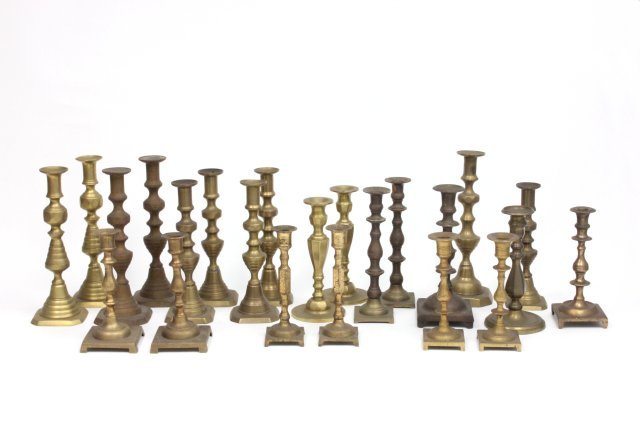 23 brass candlesticks: Including 9 pairs and 5 odd candlesticks.
