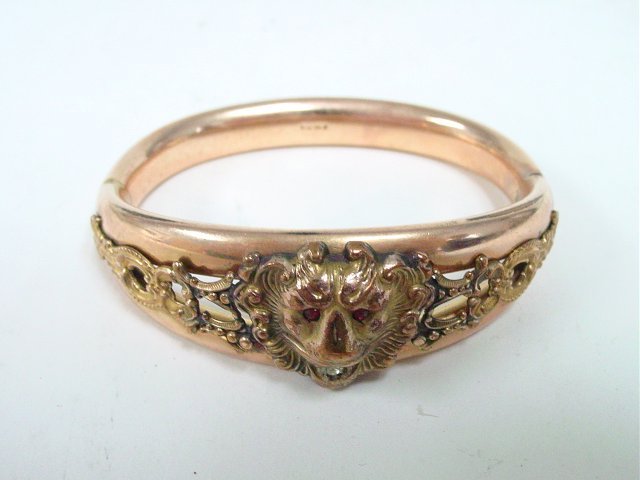 Costume Lazar Finberg bracelet: Late 19th-early 20th c., marked. "Lion" bracelet by Lazar Finberg marked with letters FMCO, hinged oval shaped band with a soldered top of a raised "Lion Head" with ruby eyes & CZ in mouth. Approx. 2"