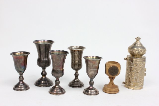 7 Judaica pieces: 6 Kiddush cups, silver plated & wood; & torah holder.