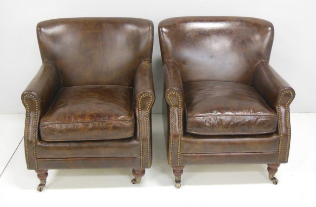 Pair of vintage leather arm chairs: With button design on front & sides. Approx. 30.5" H x 26.5" W x 32" D.