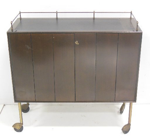 Paul McCobb for Calvin/Directional Bar cabinet: With brass gallery & wheels. Approx. 36" W x 15" D x 36.5" H.