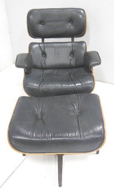 Rosewood swivel chair with matching footstool: Possibly done by Eames. From the estate of Anita Stern