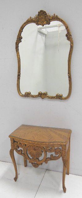 Heavily carved walnut console table with mirror: Gilt over hanging mirror