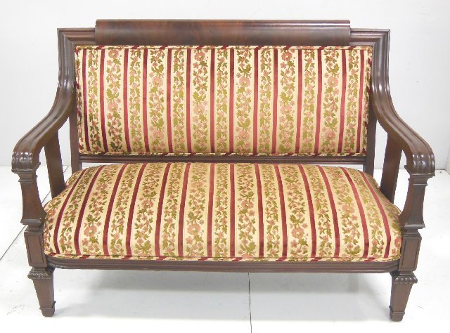 American Empire mahogany loveseat ca. 1880's: With striped upholstery. Straight backed, mahogany wood frame with curved wood arms. Approx. 39.5" H x 53" W x 29" deep.
