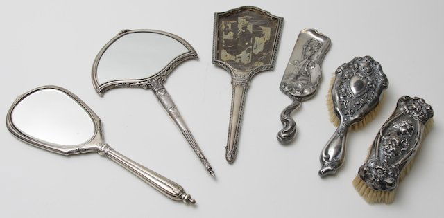 6 silver vanity pieces: Including: 3- sterling silver hand mirrors, i missing glass. 1- Brush. 1- Silver plated crumber & brush.