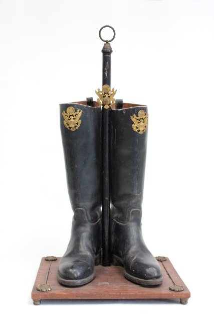 Empire style mahogany umbrella stand: From the Estate of Chris Peckham. Gilt metal mounted. Incorporating boots. Approx. 25" H. Leather slightly worn. Brass lifting on base. Base cracked and worn.