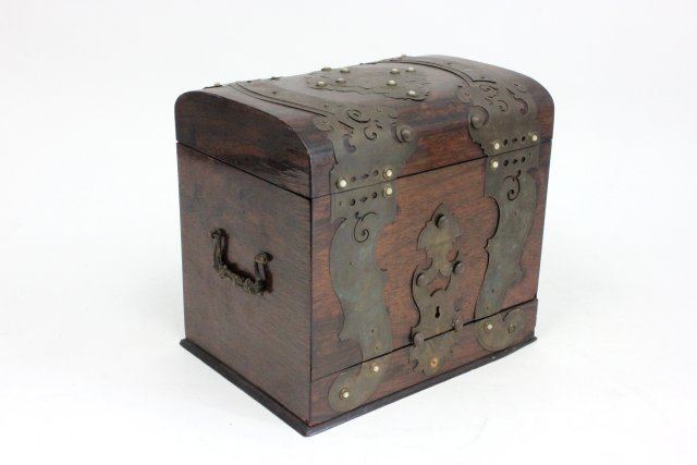 19th c. rosewood tantalus case: From the Estate of Chris Peckham. With brass and mother-of-pearl trim. Approx. 10" W x 9" H x 7" D. Veneer chips on side. 3 pieces of mother-of-pearl missing. No interior bottles or glasses. Missing p