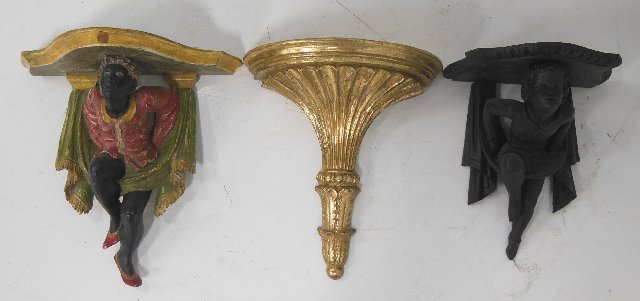 3 wood carved wall brackets: From the Estate of Chris Peckham. Including 2 figural wall brackets, 1 ebonized young boy, approx. 14" H x 10.5" W x 8" D, 1 gilt fluted composition, approx. 16" x 13.5" W x 7" D. And 1 patinated carv