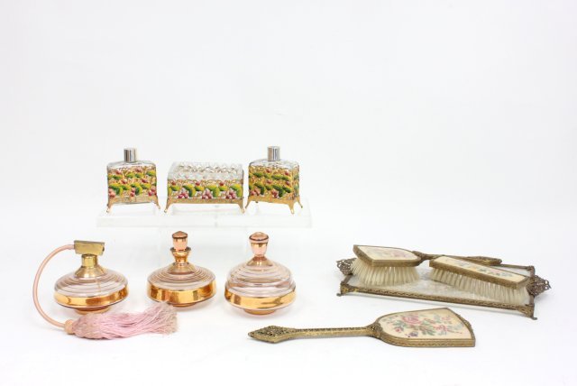 3 vintage vanity sets ca. 1920's & 1950's: 1- 3 piece depression glass set, including atomizer & 2 covered jars. 1- 3 piece enamel over metal framed set, including 2 bottles & ring box. 1- 3 piece set, including vanity tray brush, hand mirror 
