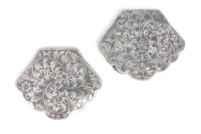 2 matched silver compacts with floral design: Approx. 2.75" x 3.125". From the Estate of Anita Stern