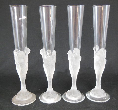 4 Erte figural frosted & clear champagne flutes: Signed at the bottom. Approx. 12" H.