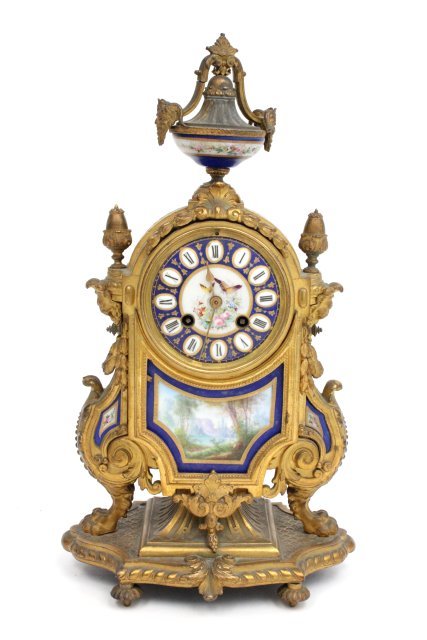 Bronze, metal & porcelain mantle clock: With pendulum. Approx. 16.5" H.