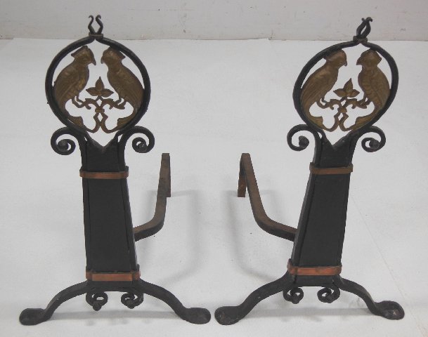 Early 20th c. iron & brass parrot relief andirons: Approx. 21.5" H x 13" W. From the Estate of Chris Peckham.