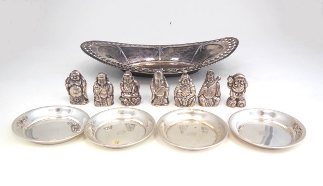 Lot of sterling silver: Including: 4 nut dishes, bread tray, 7 Chinese figural salt & pepper shakers. Approx. weight 11.30 ozt. From the estate of Chris Peckham.