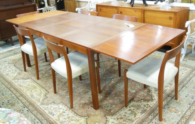 Mid- century teakwood dining room set: Including: Drop leaf table, 6 side chairs & sideboard with sliding doors.