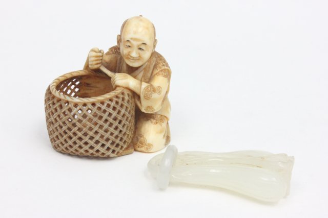 Carved Netsuke artist signed & carved jade item: Netsuke depicting "Seated Man with Basket". From the estate of Chris Peckham.