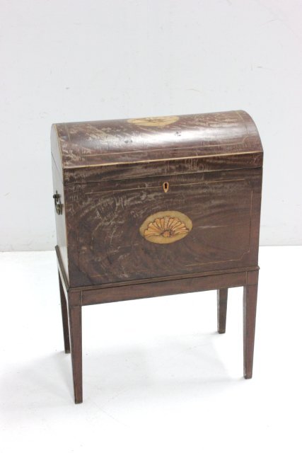 George III inlaid mahogany cellarette on stand: Finish worn, inlay missing on top shell. Approx. 29" H x 20.5" W x 11" D. From the estate of Chris Peckham.