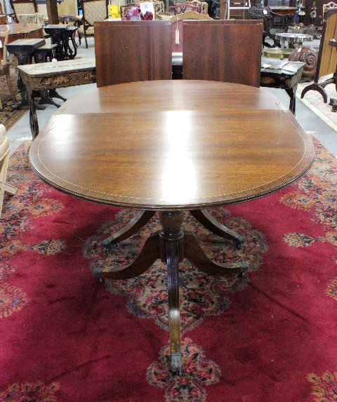 Regency style brass inlaid dining table: With mahogany pedestal. Appros. 29.5" H x 40" W. Extended approx. 102". Each approx. 21". Condition: Brass lifting in places, veneer missing on feet, finish lifting in places. From the estate of Chris