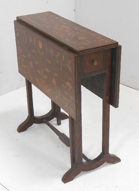 Inlaid mahogany drop leaf table ca. 1910's - 20's: With floral motif and pedestal legs. Approx. 25.5"H x 24"D x 7.5"W, with 2 - 11" W drop leaves. Including drawer. From the estate of Chris Peckham.