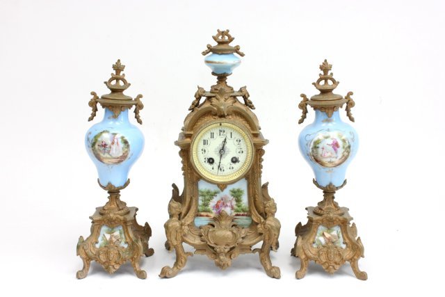 3 piece gilt metal & porcelain French clock set: With pendulum, handpainted, figural, metal painted gold, top of the finial on clock is broken off. Clock approx. 17" Hlate 19th/early 20thc